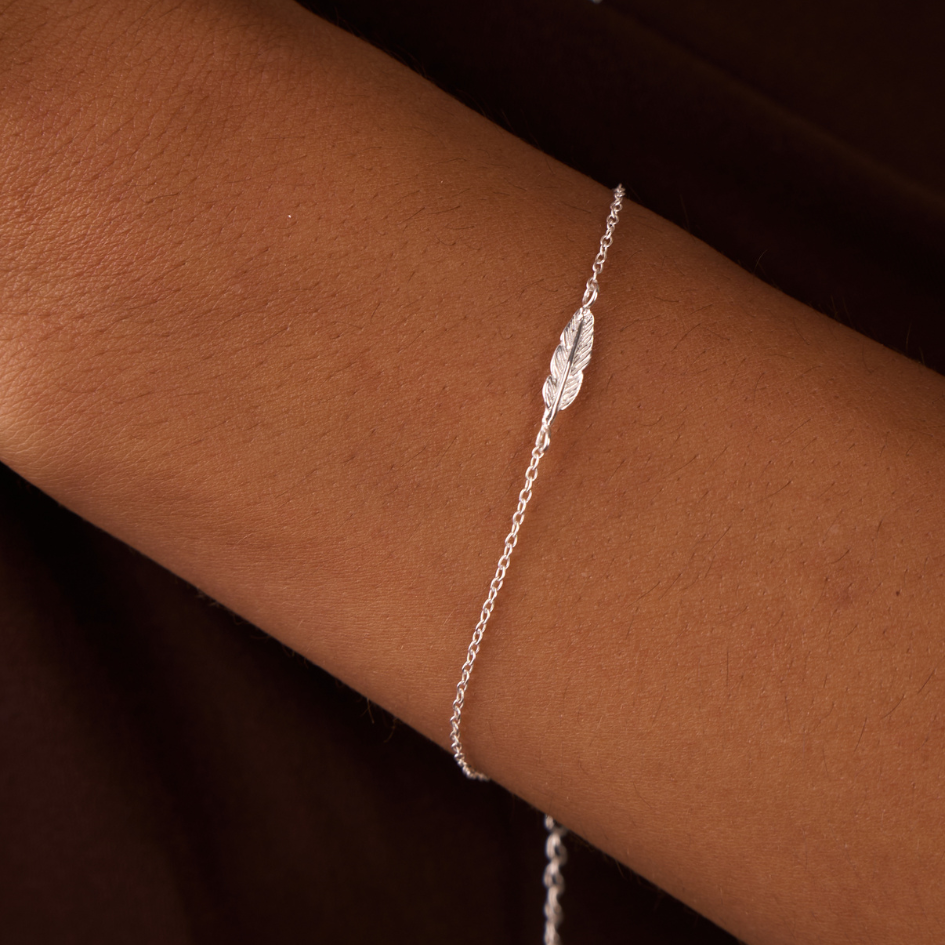 women with bracelet silver feather